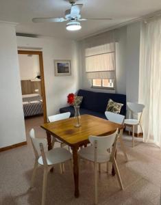 a living room with a wooden table and white chairs at Apartamento CA VALEN 6 in Peniscola