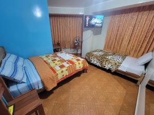 Postel nebo postele na pokoji v ubytování Hospedaje Leo + 6 fotografií