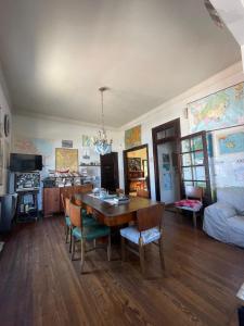a living room with a wooden table and chairs at Republica Hostel in San Pedro