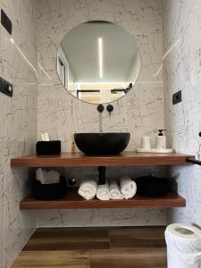 a bathroom with a sink and a mirror and towels at Bellavista - Superior rooms in Agerola +13 photos