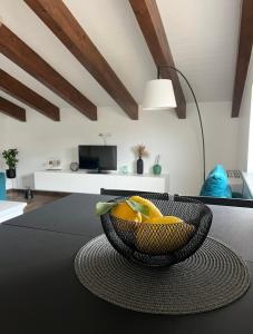 a basket of fruit on a table in a living room at Bellavista - Superior rooms in Agerola