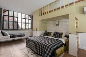 a bedroom with a large bed and a staircase at Sloth Loft Montmartre 2025 Refresh in Paris