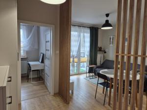 a living room with a table and a living room with a couch at Torowa 2a Apartamenty El-Bema in Biała Podlaska +14 photos