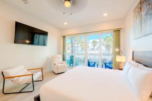 a bedroom with a white bed and a window at Starfish Shores in South Padre Island