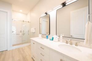 a white bathroom with a sink and a mirror at Starfish Shores in South Padre Island +15 photos