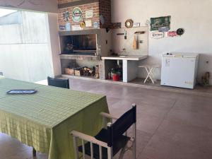 a room with a table and a kitchen with a fireplace at Home J y M in Concordia