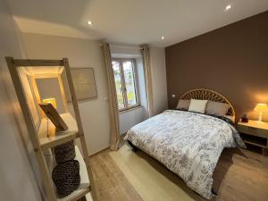 a bedroom with a bed and a window and a mirror at Appartement Pontarlier-centre in Pontarlier