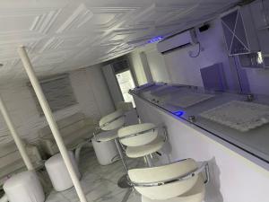 a laboratory with four chairs and a counter in a room at Ibiyemi apartment in Abuja +81 photos