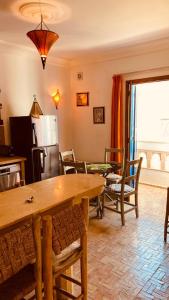 a kitchen and living room with a table and chairs at apparemment 3 ème étage à-côtés de la plage in Essaouira