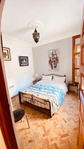 a bedroom with a bed and a chair in it at apparemment 3 ème étage à-côtés de la plage in Essaouira