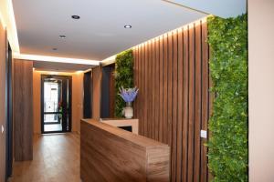 a lobby with a wooden fence with a plant at Zafiro 17 Kolašin in Kolašin