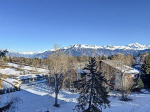 an aerial view of a house in the snow with mountains at La Duchesse in Crans-Montana