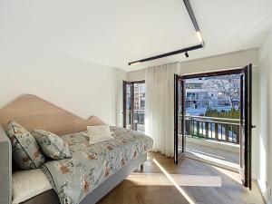 a bedroom with a bed and a large window at La Duchesse in Crans-Montana