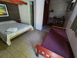 a small bedroom with a bed and a kitchen at Departamento PB 2 Centro Pileta in Formosa