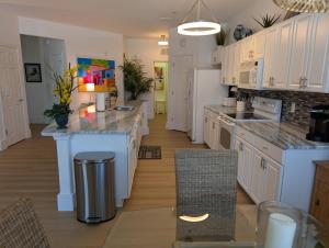 a kitchen with white cabinets and white counter tops at 3Bedroom, 2 Bathroom Condo in gated community in Fort Myers