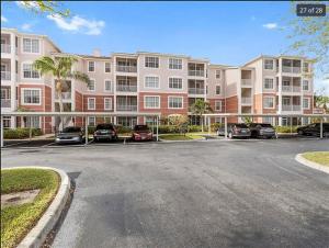 a parking lot in front of a large building at 3Bedroom, 2 Bathroom Condo in gated community in Fort Myers