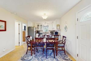 a kitchen and dining room with a table and chairs at Lakae Breakaway in Emerald Isle