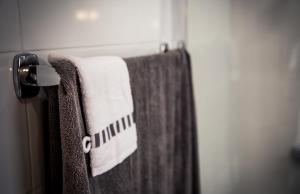a towel hanging on a towel rack in a bathroom at Casa Mãe Deus - House Azores in Ponta Delgada +53 photos