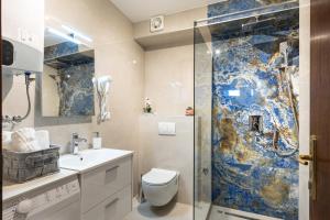 a bathroom with a shower and a toilet and a sink at Apartment Luna i Lucky in Dubrovnik +102 photos