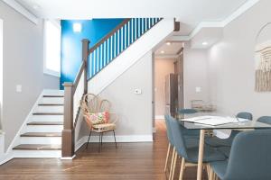 een eetkamer met een trap en een tafel en stoelen bij Adorable Broad Ripple Duplex in Indianapolis