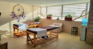 a living room with two tables and a bench at Reserva del Mar Club de playa - Apto Frente al Mar in Santa Marta