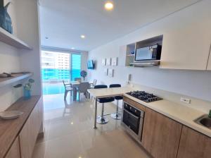 a kitchen with a stove and a counter top at Reserva del Mar Club de playa - Apto Frente al Mar in Santa Marta