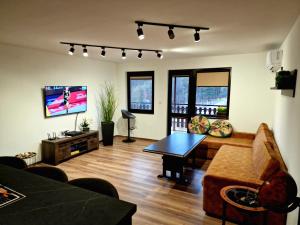 a living room with a couch and a table at Rebeka Luxury Apartment in Tryavna