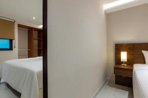 Postel nebo postele na pokoji v ubytování Hotel 28 Cancun