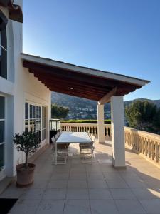 a patio with a table and chairs on a building at Villa with amazing sea views in Port d’Andratx +24 photos