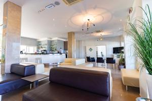 a living room with a couch and chairs and a bar at Hotel Bellevue in Cattolica