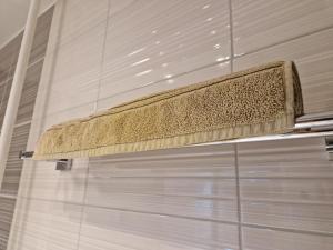 a towel rack in a shower in a bathroom at Erzsebet Apartman, free parking in Budapest +10 photos