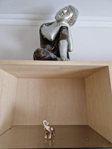 a statue of a woman and a dog on a shelf at Erzsebet Apartman, free parking in Budapest