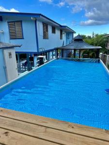 a large blue swimming pool in front of a house at Sea Breeze Paradise in Cabo Rojo