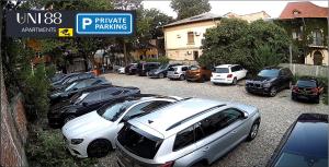a row of cars parked in a parking lot at Crown Penthouse - Luxurious, Spa & Vista , by Uni88 ApartHotel in Bucharest