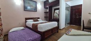 Un pat sau paturi într-o cameră la Hotel Rosa de los vientos