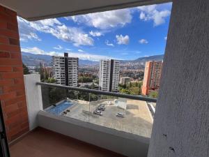 a balcony with a view of a city at Apartment in Envigado with a pool in Envigado