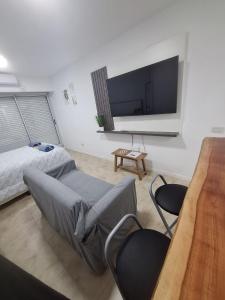 a bedroom with a bed and a flat screen tv at Departamento en Rosario centro 2 in Rosario