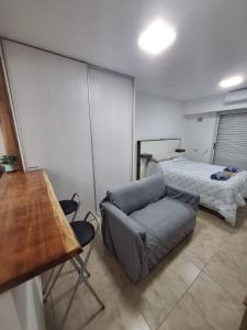 a living room with a couch and a bed at Departamento en Rosario centro 2 in Rosario