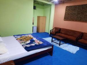 a living room with a bed and a couch at Sky resort ajk patikka in Muzaffarabad +30 photos
