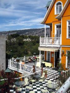 a patio with tables and chairs in front of a building at Sky resort ajk patikka in Muzaffarabad