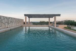 a large pool of water with a gazebo at Beautiful Loft near the Beach in Playa del Carmen