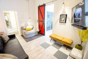 a living room with a couch and a chair at Unique denver loft in rino art district in Denver