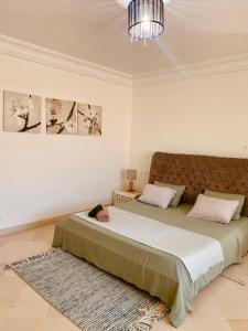 a child laying on a bed in a bedroom at Le luxe de Sidi Bou Saïd in Sidi Bou Saïd