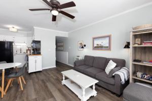a living room with a couch and a table at Oceanfront Bliss at Wave Raider -Perfect Getaway in North Topsail Beach