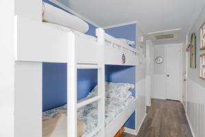 a bunk bed room with two bunk beds at Oceanfront Bliss at Wave Raider -Perfect Getaway in North Topsail Beach +34 photos