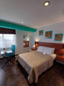 a bedroom with a large bed and a desk at Hotel Vila Santa in Lima +82 photos