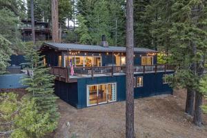 a blue house in the middle of the forest at Updated Cabin near Beach&Ski HotTub Sauna Pets EV in Tahoe City