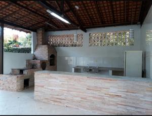 a large kitchen with a counter and a sink at Pousada Recanto do Sabiá in Barcarena