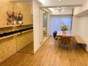 a dining room with a table and chairs at World House Kameido -Direct to Akihabara&Shinjuku, near Asakusa &Skytree, 30 mins to Disney by train in Tokyo