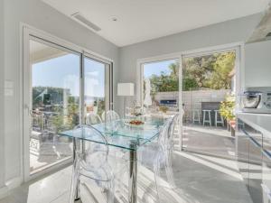 La NartelleにあるLa Meréveilのガラスのテーブルと椅子のあるダイニングルーム
